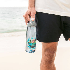 man holding nalgene bottle with hula dancer design on beach