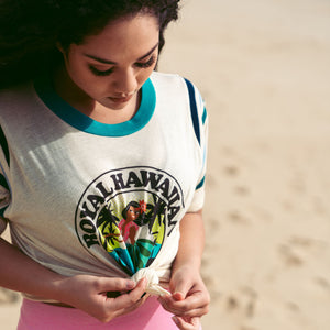 woman tying her vintage white t-shirt with hula dancer design on it