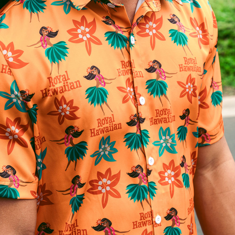 close up of man wearing yellow button up shirt with hula print all over it